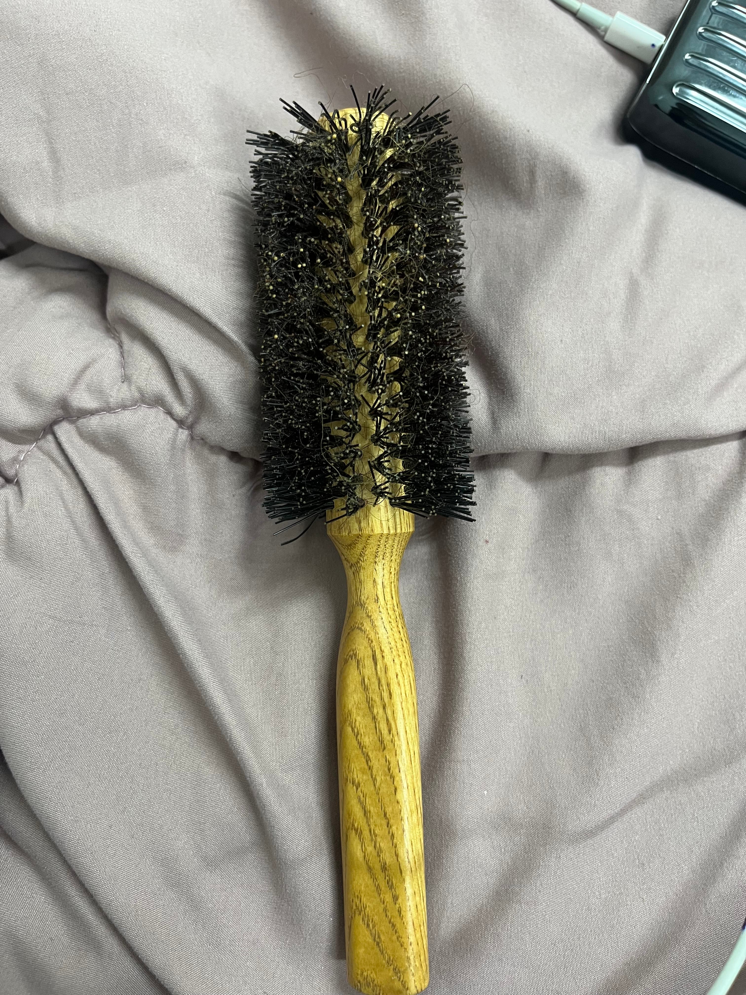 Close-up image of the defects in the bristles of the poor quality hair dryer brush